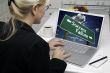 Woman In Kitchen Using Laptop