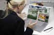 Excited Woman In Kitchen Using Laptop - Real Estate Success