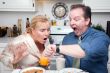 Stressed Couple in Kitchen Late for Work