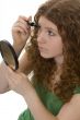 red haired female teenager with mascara