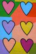 Colorful graffiti spray painted funny hearts on the decorated  b