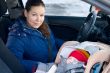 Mother and child in car safety seat