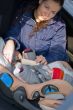 Mother and child in car safety seat