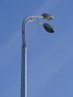 two grey street lamppost in blue sky