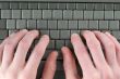 Male fingers on keyboard