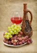 Ceramic bottle, grapes and red wine