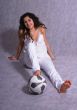 Beautiful girl sitting on a floor with a ball