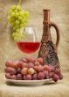 Ceramic bottle, grapes and red wine