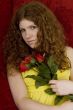 red haired teenager with red roses