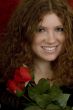 red haired teenager with red roses