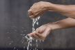 A man washing hands with water