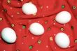 White eggs on the red textile