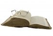 Vintage open book bible open and glasses on it isolated over whi