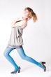 Teenager in blue pantyhose and grey blouse posing