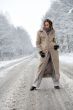 Winter landscape woman standing on a snowy road