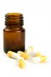 glass bottle with yelllow capsules