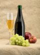 Champagne bottle, goblet, grapes, apple and peach