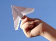 child hand with paper plane