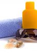 towel, sunglasses and lotion
