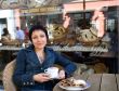 Young beautiful woman with a cup of hot cappuccino