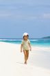 A young girl walking on the beach