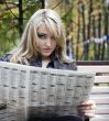 Young woman reading a newspaper