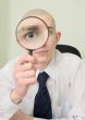 Guy looks through the big magnifier