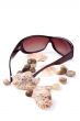 sunglasses, shells and pebbles