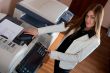 Young business woman at photocopier