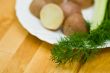 Potatoes, salt cucumber and dill still-life