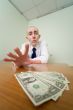 Man reaches for a batch of money