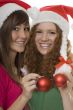 Christmas, happy teenagers with Christmas tree ball
