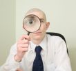 Guy looks through the big magnifier