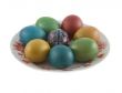 The easter decorated eggs lying in white porcelain plate with a