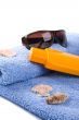 towel, shells, sunglasses and lotion
