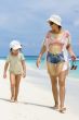 Daughter and mother walking on the beach