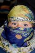 Curious child dressed in Arabian headscarf