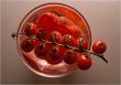Bright red tomatoes in a bowl with water.