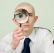 Guy looks through the big magnifier