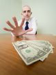 Man reaches for a batch of money