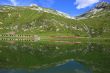 Train behind a lake with mountain and train