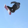 Snowboarder jumping high in the air