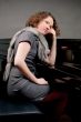 pretty young girl near piano thinking smiling