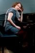 pretty young girl near piano thinking