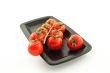 tomatoes bunch on a black plate