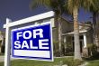 For Sale Real Estate Sign and House
