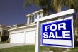 For Sale Real Estate Sign and House