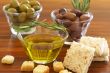 Two jars of green and black olives and croutons