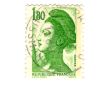 Old green french postage stamp with woman
