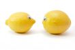 Two funny lemons with eyes on white